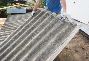 Asbestos cement roofing sheets being handled during commercial asbestos removal work
